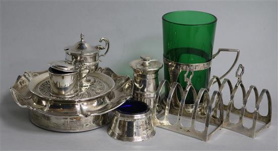 Assorted silver including two toastracks, three cruets, pepper mill, cup holder and a coaster.